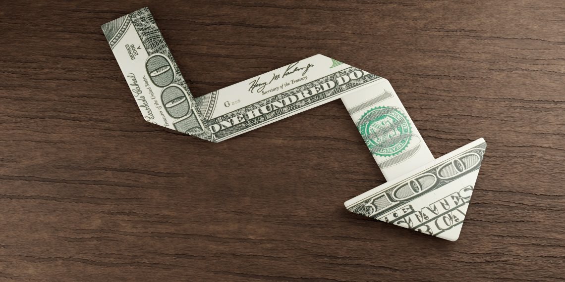 U.S. dollar bill points downward, symbolizing the decline in the dollar's dominance, particularly in the Middle East.